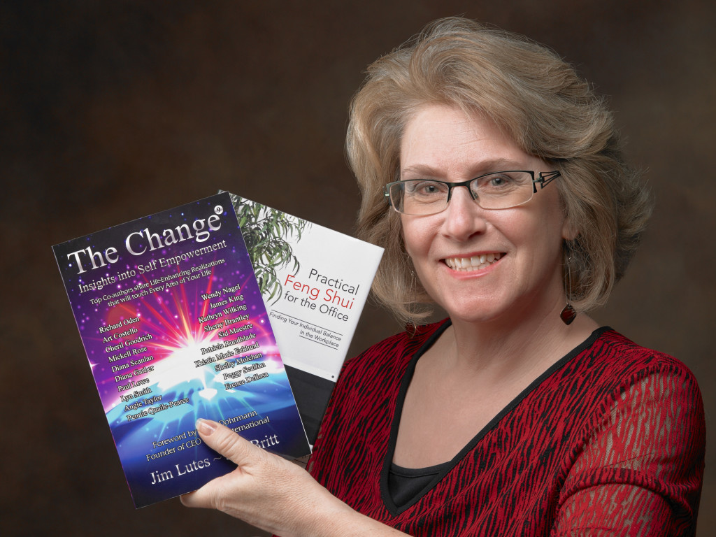 Image of Kathryn holding two books she has authored.